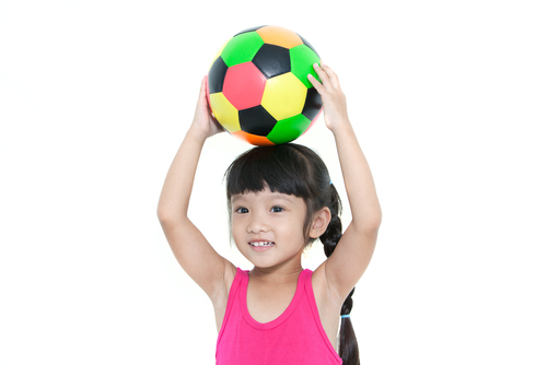 girl holding football